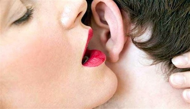 girl whispering on boy ear