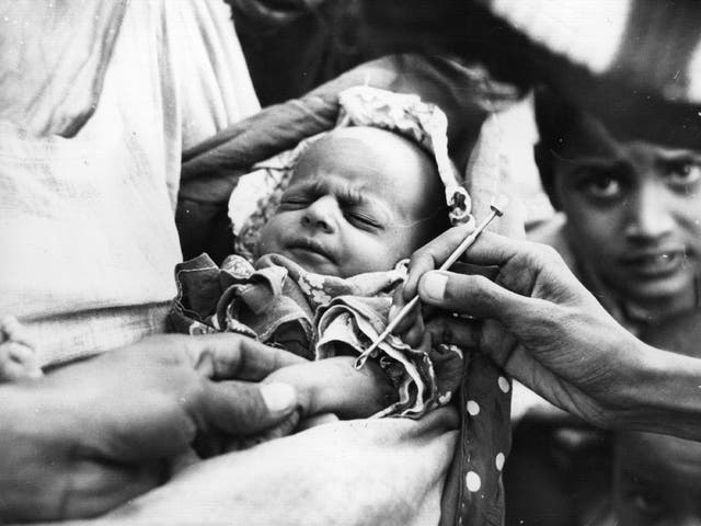 A baby is vaccinated against smallpox at an emergency clinic of tata group