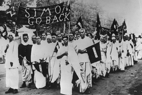 People march in a protest against Simon