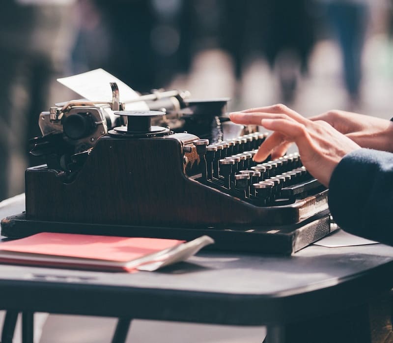 person using typewriter