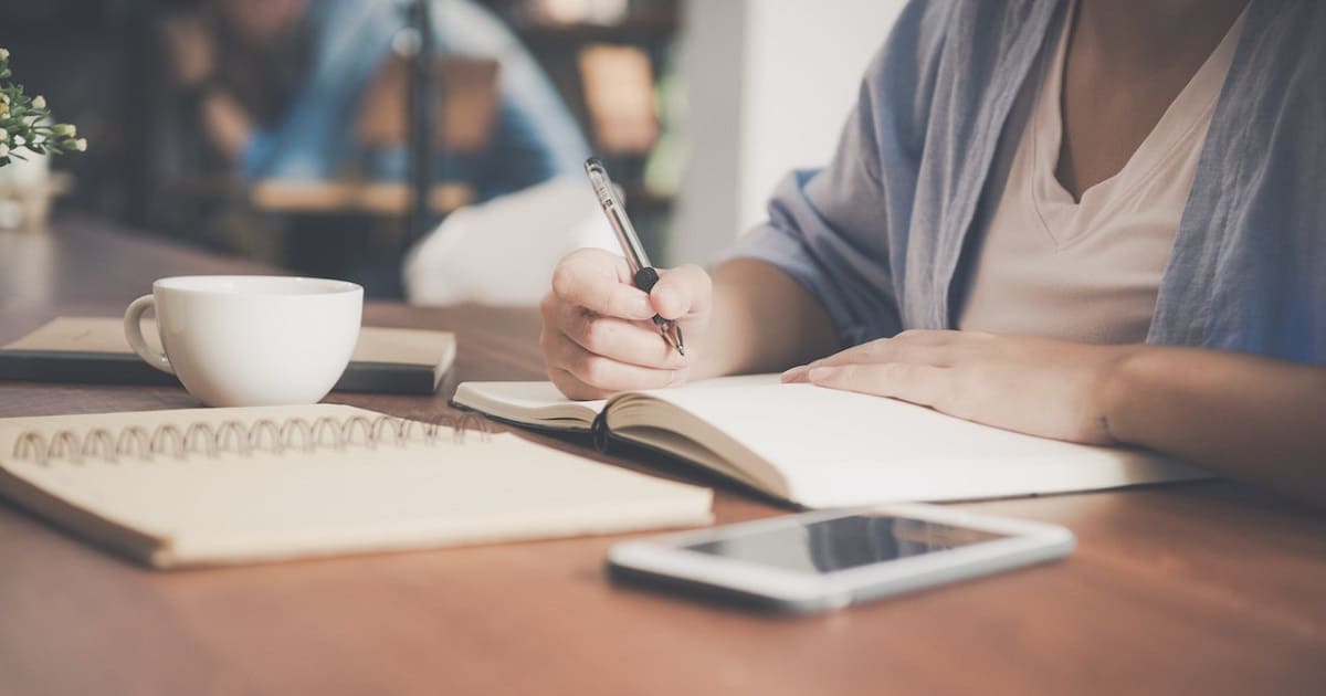 Man writing on notebook