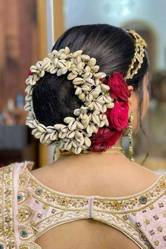 Hairbun styled with cowrie shells