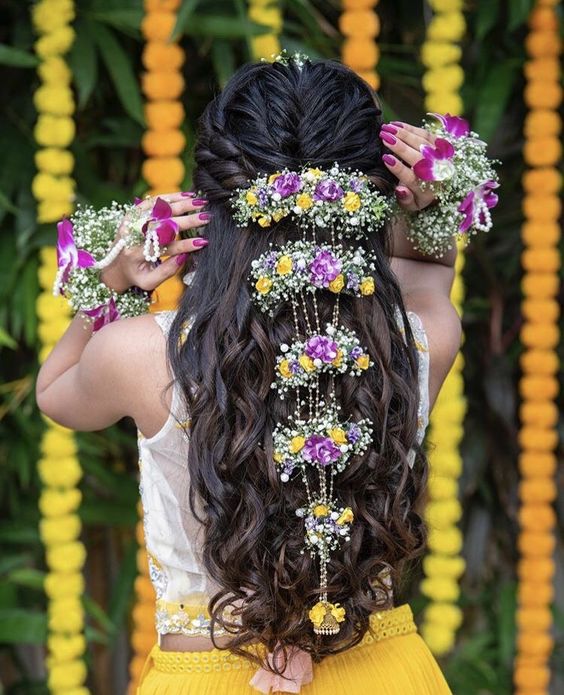Open hair hairstyle for lehenga with layers of flowers