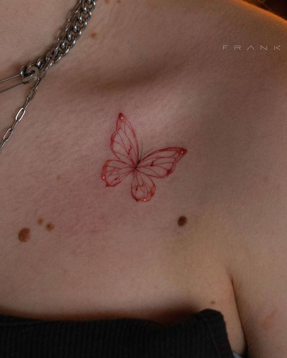 Red ink collarbone tattoo