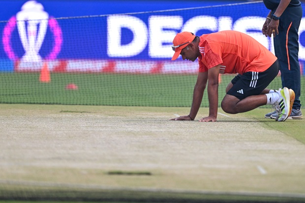 India coach Rahul Dravid inspects the pitch at the Narendra Modi Stadium in Ahmedabad on November 18, 2023, on the eve of their 2023 ICC Men's Cricket World Cup one-day international (ODI) final match against Australia. 