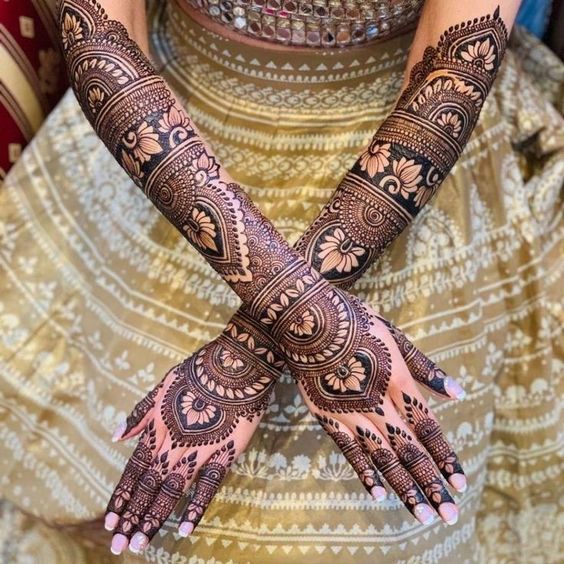 full hand bridal henna design with flower motifs