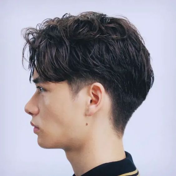 Low taper fade with curtain bangs