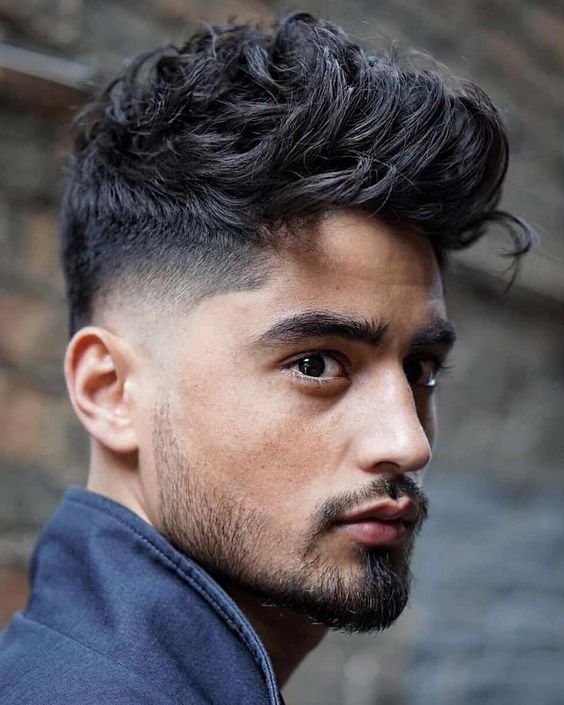 Messy pompadour with low taper fade