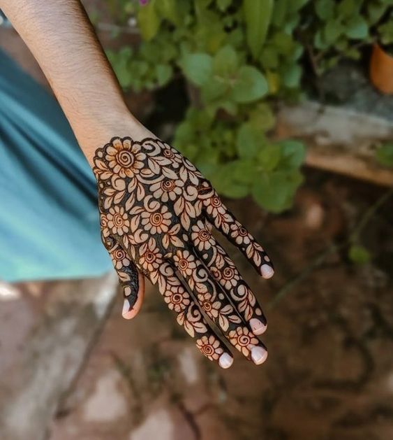 Negative floral mehndi design back hand