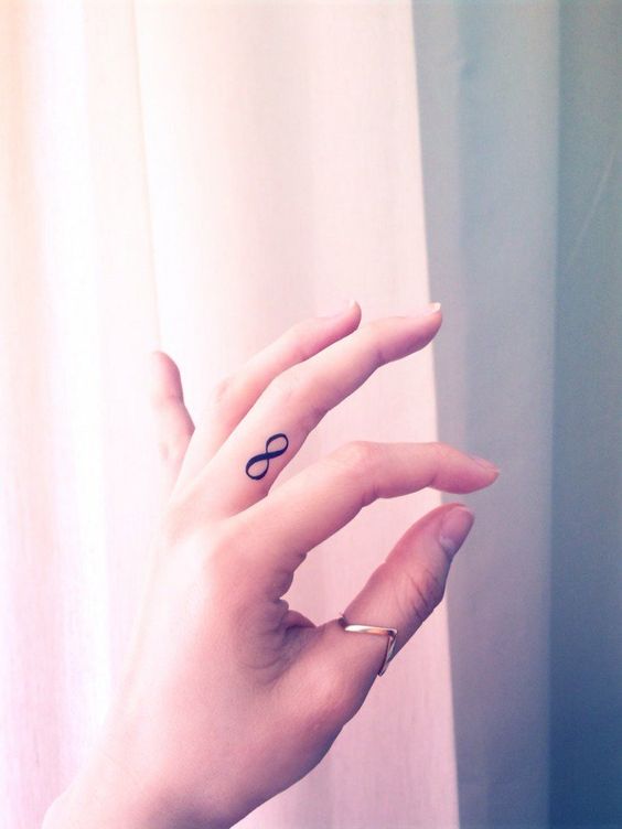 Minimalistic infinity symbol finger tattoo