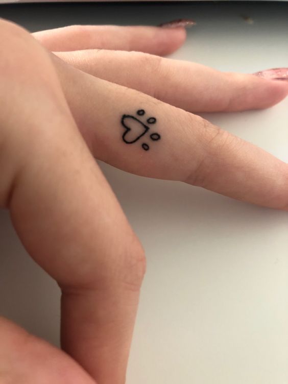 pug mark finger tattoo
