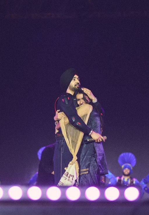 Diljit hugging his fan onstage