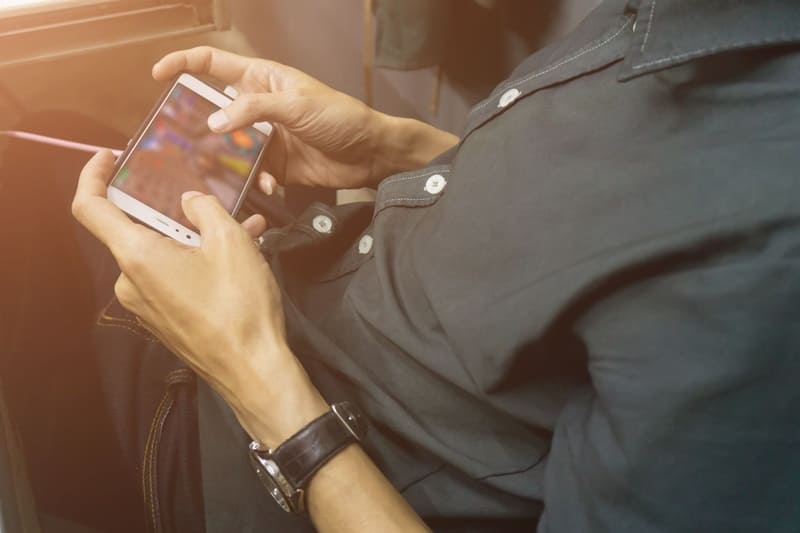 man playing game on phone